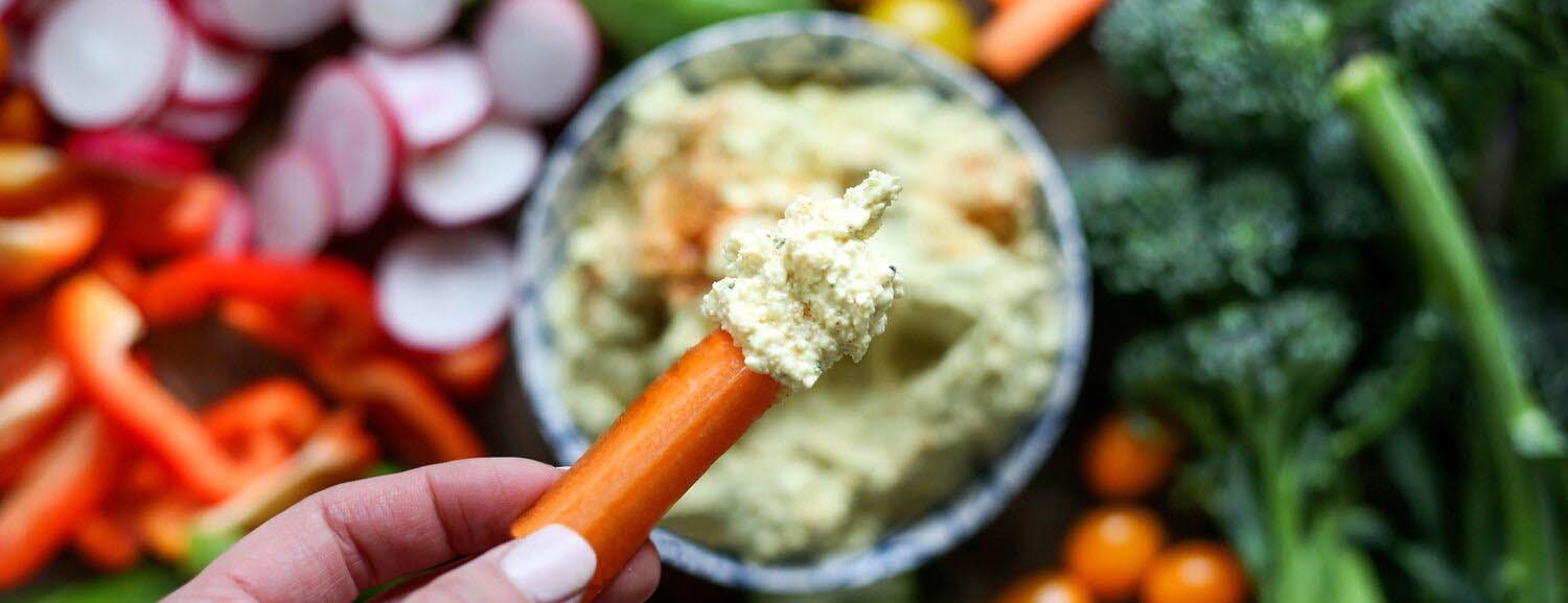 carrot dipped in Toby's plant based dip & spread